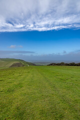 Fototapeta premium Looking towards Truleigh Hill in West Sussex with a blue sky and fluffy clouds overhead