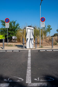 Modern electric charging station in empty parking bay for vehicle showing sustainable mobility infrastructure with clean energy power system