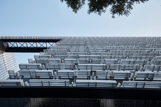 Low angle view of modern building facade with repetitive glass and metal louvers