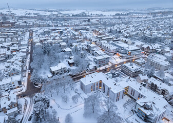 Aerial photo of a snowy area with residential buldings, shpping center and administrative buildings in the city of Kornwestheim in Baden-Wuerttemberg, Germany

