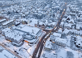 Aerial photo of a snowy area with residential buldings, shpping center and administrative buildings in the city of Kornwestheim in Baden-Wuerttemberg, Germany

