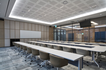 Professional conference room with long tables and chairs
