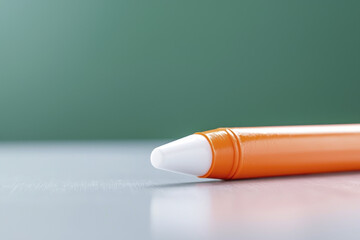 Orange marker white tip close up plastic writing tool office supply stationery horizontal macro isolated green background modern clean minimal focus detail education classroom drawing art creative