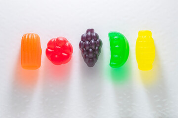 Row of Brightly Colored Gummy Candies on a White Surface