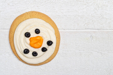 Giant Snowman Sugar Cookie on a White Wood Table