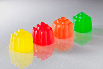 Row of Sour Gummy Candies with a Reflection on a White Surface