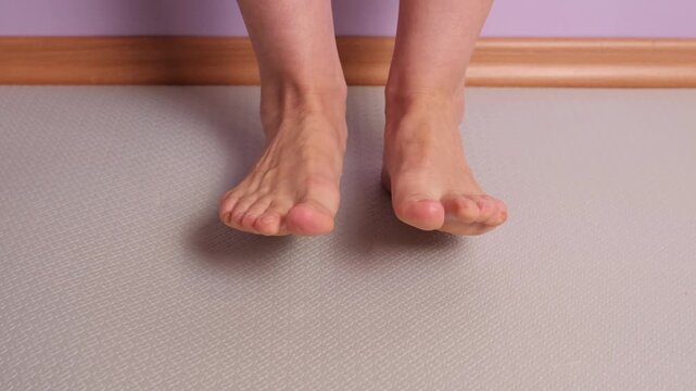 Set of exercises for the feet: Rolling the foot from toe to heel. Front view. Controlled rolling movement from toes to heels, foot mobility exercise that improves coordination and joint flexibility.