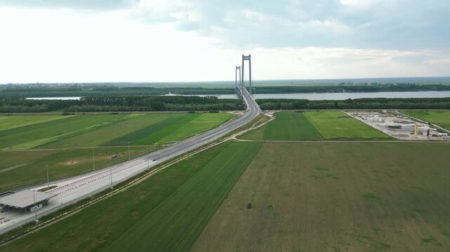 The Brăila Bridge, Road Suspension Bridge In Romania Over The Danube River. Aerial Pullback Shot