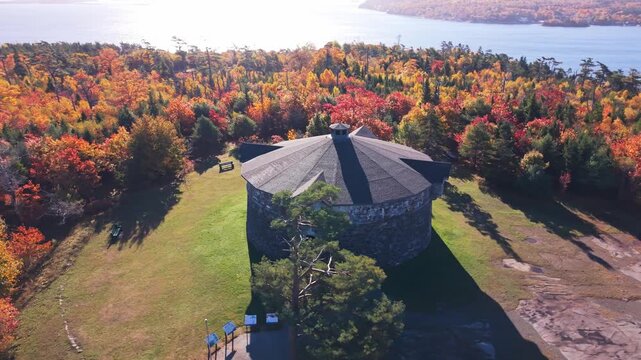 Aerial view From The Sky Ancient Fortress Tower Sits In Center Of Bright Autumn Parkland In Nova Scotia. Golden Hour Drone Footage Of Canadian Historical Gem. 
