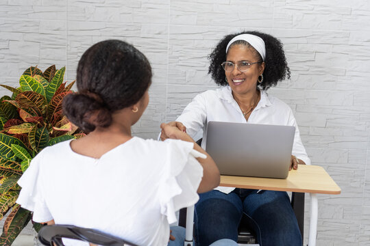 Student celebrating university acceptance shaking mentor's hand