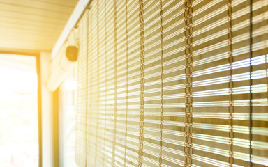 Bamboo blinds with warm sunlight through window. Natural light creates a cozy and relaxing interior background, ideal for design, lifestyle, home, and minimal concepts