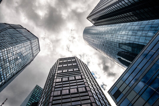 Dramatic monochrome architecture skyscraper office facade perspective with clouds and contrast in Frankfurt Germany business district skyline