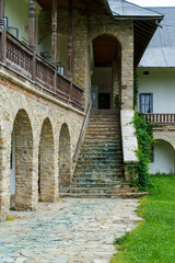 Naklejka premium view of the facade of an old house with a porch and arches