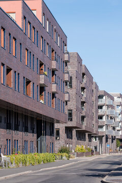 Empty urban residential street with modern apartments facade windows in daylight creating a clean neighborhood housing background with copy space
