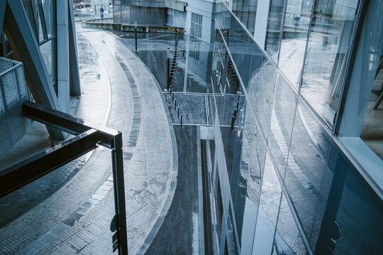 Modern interior atrium with glass reflection curves and abstract geometry filled with light creating a clean architectural space and copy space background