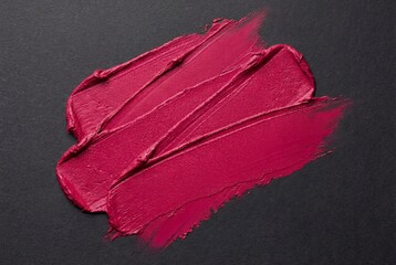 Bright fuchsia matte lipstick swatch with diagonal strokes