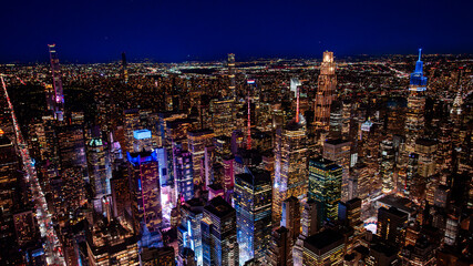 Fototapeta premium Midtown Manhattan skyline at night. High altitude night aerial of Midtown Manhattan with illuminated skyscrapers