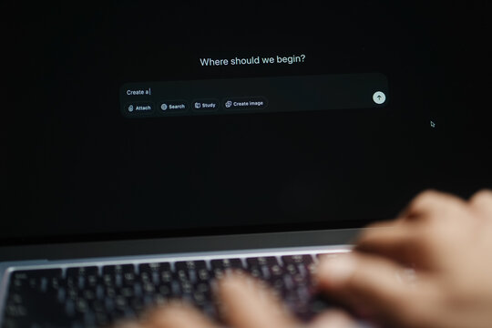 The hands of a man using a laptop or smartphone to operate artificial intelligence (AI), inputting commands and interacting with AI, AI assistants, chatbots, chat GPT.