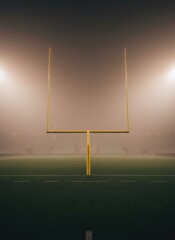 American Football Goalposts Lit Up by Stadium Lights on a Foggy Night Field