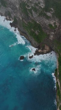 Aerial drone footage of dramatic cliff coastline with ocean waves Bali, Nusa Penida