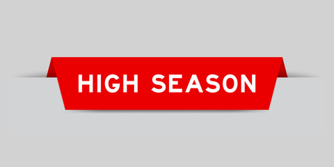 Red color inserted label with word high season on gray background