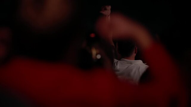 POV footage from a concert or rave. The scene begins with a crowd dancing under red lights, then transitions to chaotic motion blur and ends with abstract bokeh lights, evoking a wild night out.