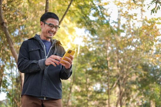 man using mobile phone holding cell phone texting message contact us.chatting,search internet shopping online.device communication connecting