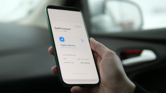 User switching mobile data connection in a vehicle using an eSIM app. Ideal for digital nomad lifestyle, international travel connectivity, and communication service promotions. Versatile footage for