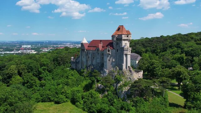 Explore the aerial view of Burg Liechtenstein in Austria, highlighting its impressive architecture and lush green surroundings. Discover the beauty of this historic site.