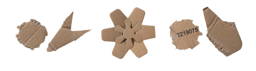 Set of torn brown cardboard fragments with rough edges, creases, cut shapes, and recycled material