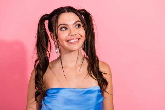 Young chic smiling brunette girl in blue strapless dress against pink background perfect for fashion lifestyle advertising