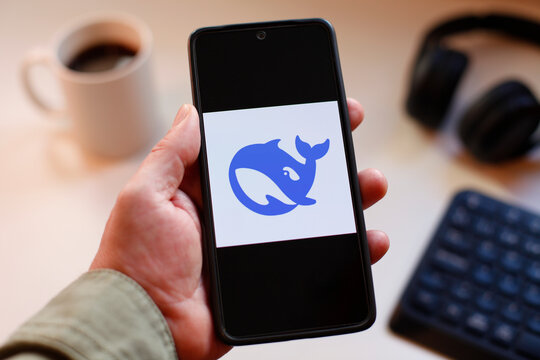 VALENCIA, SPAIN &ndash; 01-27, 2026: Smartphone With Deepseek Logo On Screen, Modern AI Assistant Concept In Workspace