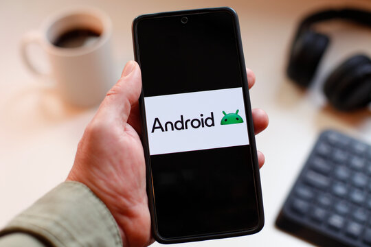 VALENCIA, SPAIN &ndash; 01-27, 2026: Close-Up Of A Hand Holding A Smartphone With Android Logo On Screen In Modern Tech Setup