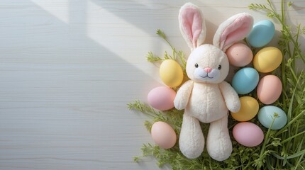 A plush bunny with pink ears sits among pastel eggs and greenery. The arrangement includes blue, yellow, and pink eggs on a light wooden surface.