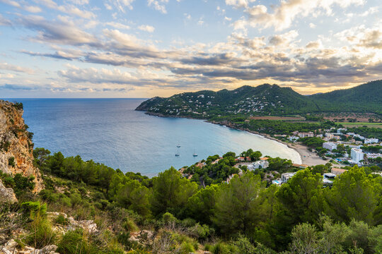 Aerial sunset view Canyamel in Mallorca, Spain, featuring resort architecture, green countryside, Mediterranean coastline. Warm evening light, summer travel destination concept.