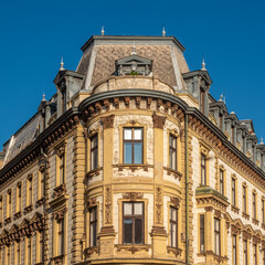 Fototapeta premium Grand architectural heritage of Pécs, Hungary, showcasing a stunning example of late 19th-century eclectic architecture on a historic street corner.