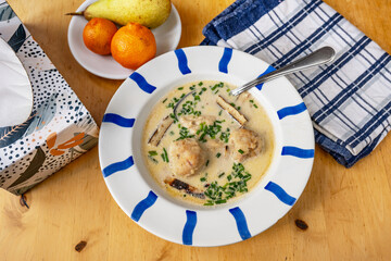 Cheese soup with bacon dumpling, towel,napkin and fruit.