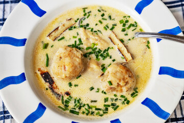 Cheese soup with bacon dumpling and celestyne noodle, closeup.