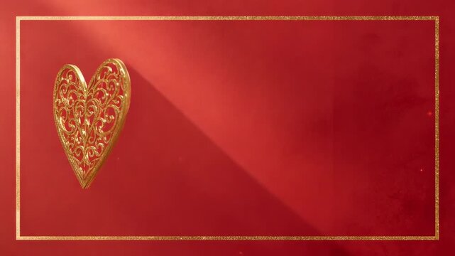 Sweeping warm light causing gold filigree heart rotating on red backdrop, gold frame, copy space