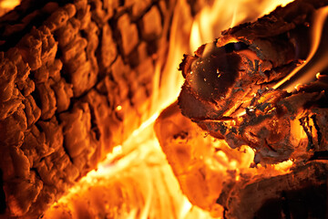 The image shows a burning briquetted fuel log in a fire. They burn cleaner, hotter, more efficiently, and longer than regular firewood.