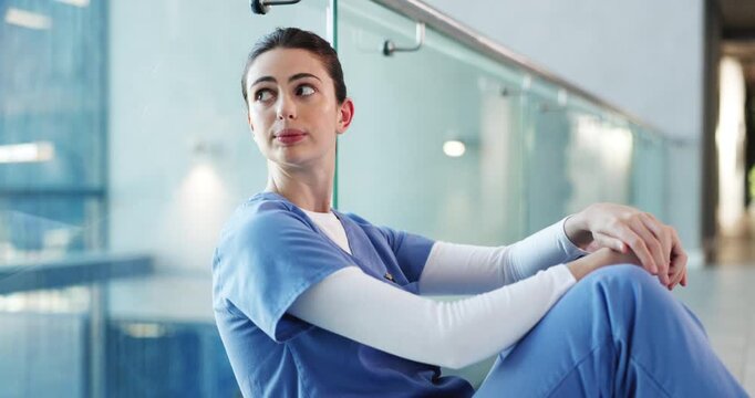 Woman, nurse and headache in grief, fatigue or mistake on floor in hospital. Mental health, sad physician and medical person with healthcare anxiety for stress, loss or failed surgery at clinic