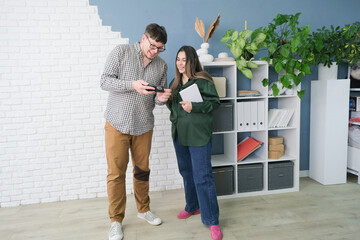 man and woman working in small office