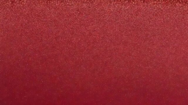 Filming red surface gaining glitter during frame sequence at studio close up, showing texture shift