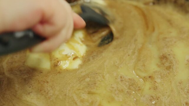 Mixing ingredients in a bowl for a dessert recipe in a kitchen while preparing for a sweet treat