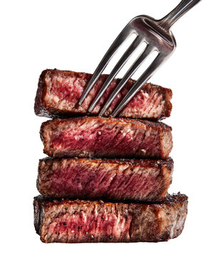Fork piercing a stack of cooked steaks