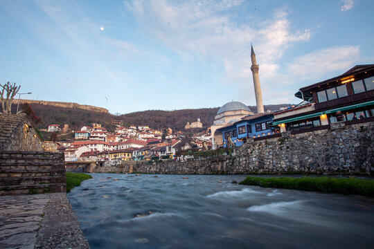 Sinan Pasha Mosque and the river in Prizren, Kosovo during sunset with buildings on the hill
