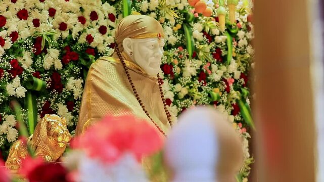A revealing video of Sai Baba or Sai Ram idol surrounded by floral decorations inside the temple