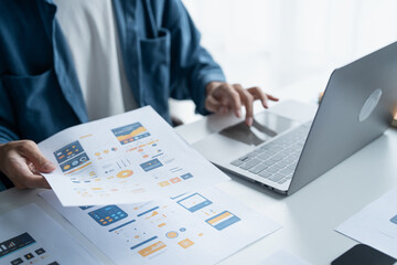 UX UI Designer Planning innovative Mobile App with Paper Wireframe Designs at Workspace.