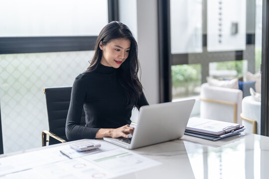 Beautiful&nbsp;confident asian business woman working with laptop Hands typing  keyboard. Professional investor working new start up project. business planning in office. Technology business
