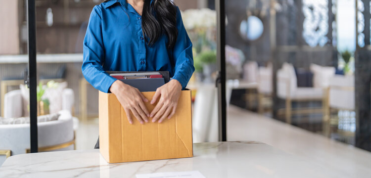 Quit Job asian business woman sending resignation letter and packing Stuff Resign Depress or carrying business cardboard box in office. Change of job or fired from company